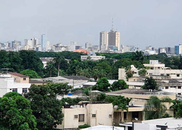 Urban cityscape with dense buildings and greenery, illustrating one of the worst cities worldwide you should never visit.