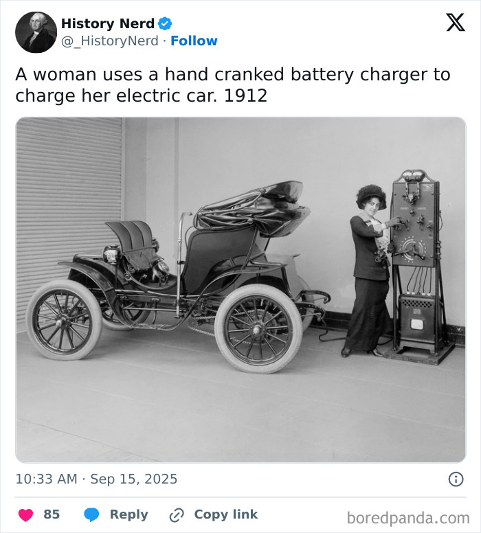A woman in 1912 using a hand-cranked battery charger to power an early electric car, showcasing rare history moments.