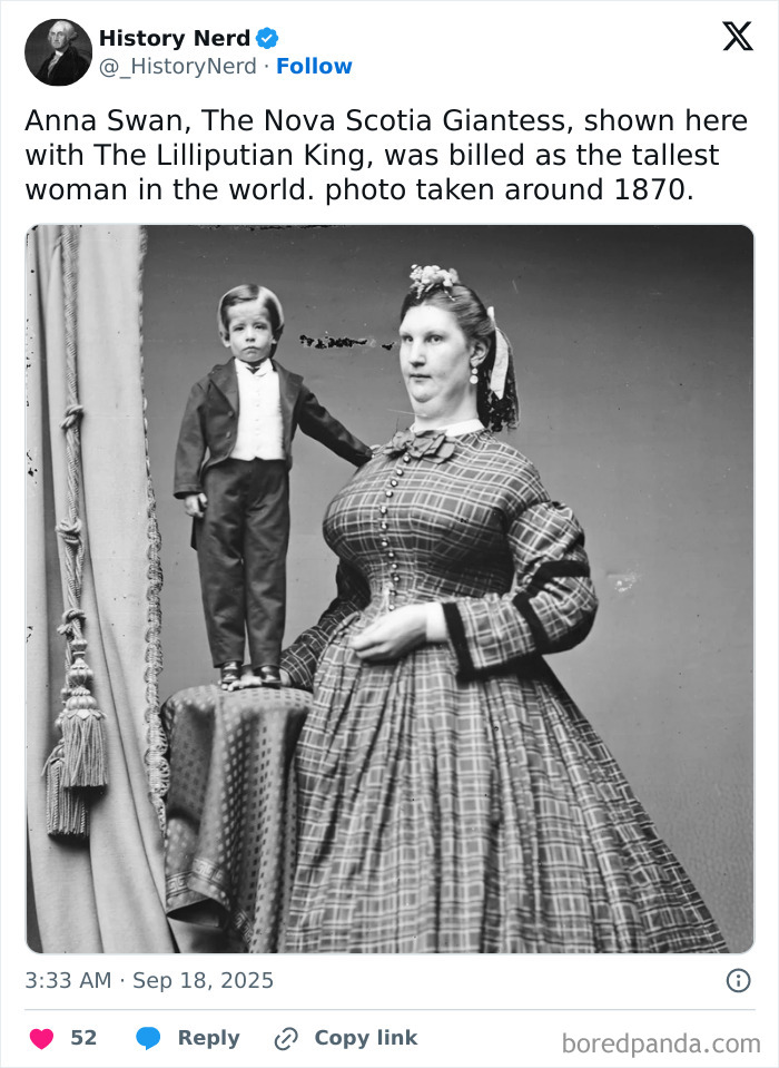Rare and powerful historical photo of Anna Swan, the tallest woman, standing beside the Lilliputian King around 1870.
