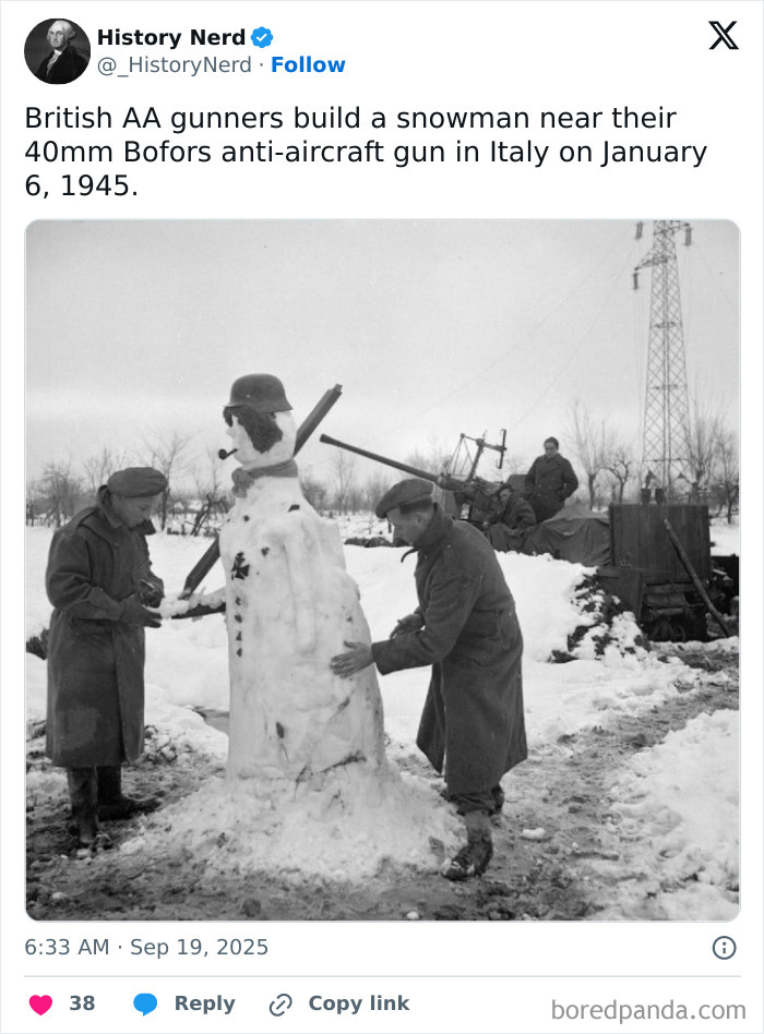British soldiers building a snowman near anti-aircraft gun during World War II in a rare historic photo.