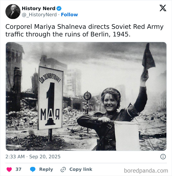Female Soviet soldier directing traffic through the ruins of Berlin in a rare history photo from 1945.