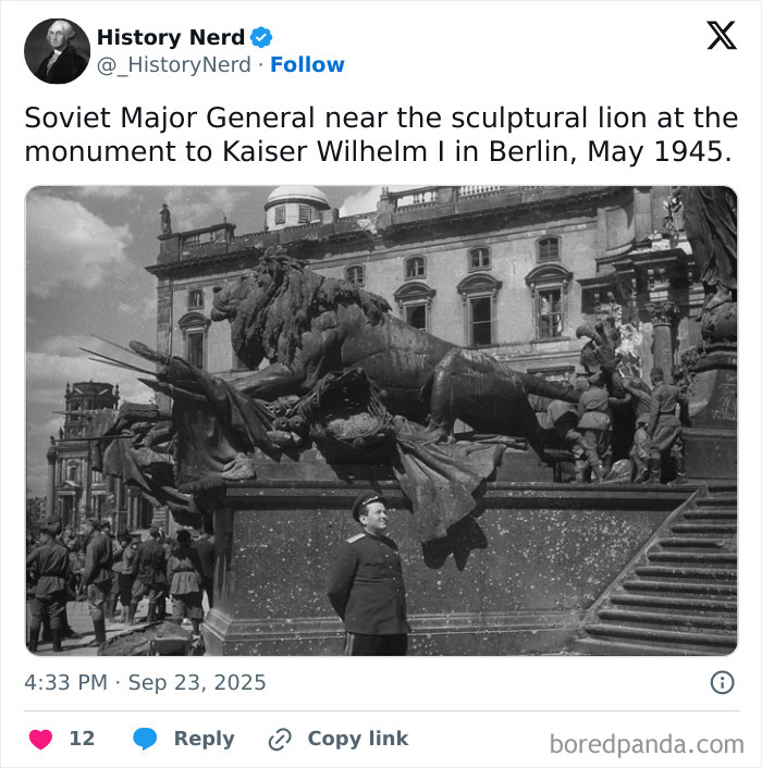 Soviet Major General standing by the sculptural lion monument in Berlin, a rare and powerful history photo from 1945.