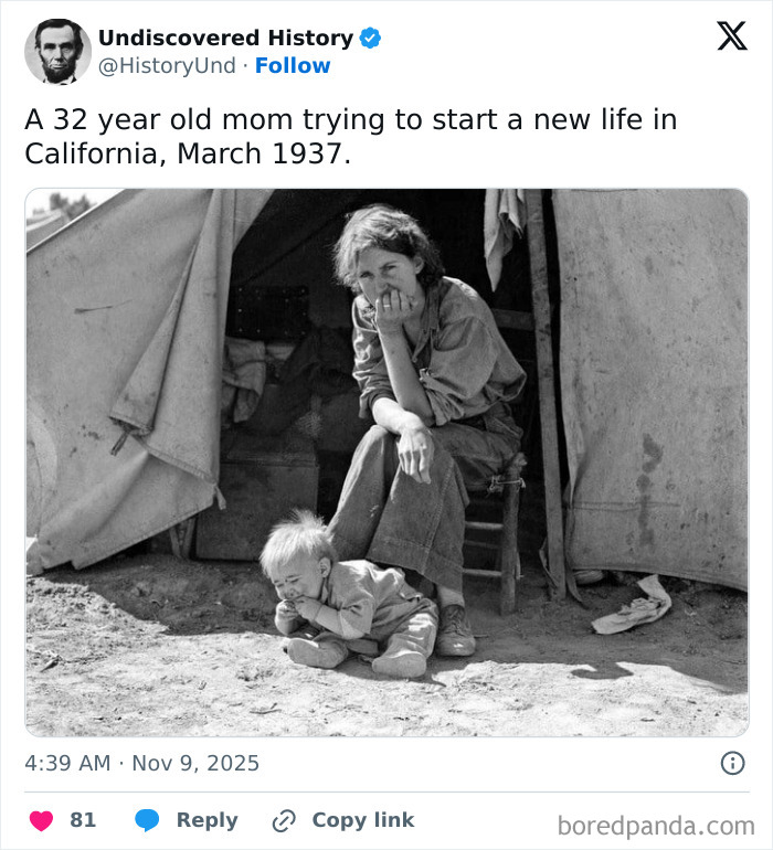 Black and white photo of a mother and child outside a tent, capturing moments lost to time during the 1930s.