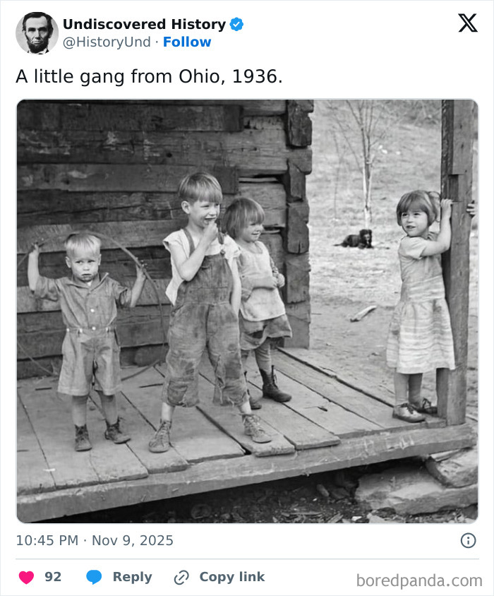 Black and white photo of four children on a wooden porch revealing moments lost to time in 1936 Ohio.