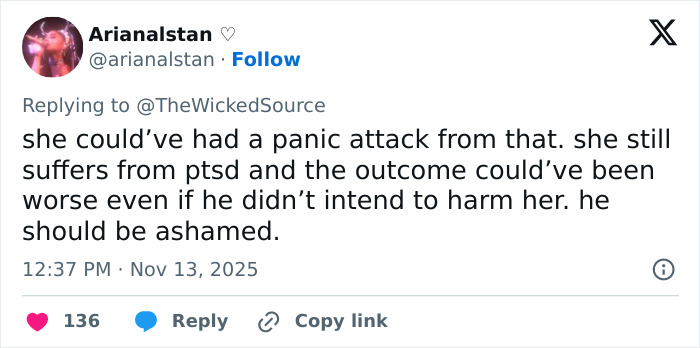 Screenshot of a social media reply criticizing a fan who attacked Ariana Grande and discussing the impact on her PTSD.