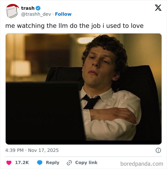 Young man in a shirt and tie looking tired and reflective while sitting at a desk, illustrating job frustration and work life.
