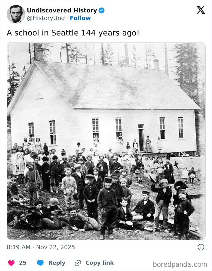 Historic photo showing a large group of children outside an old school building, revealing moments lost to time.