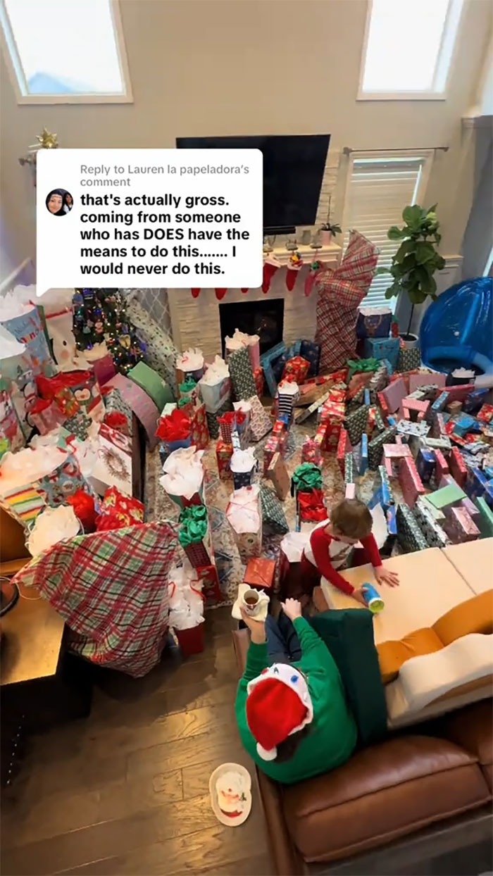 Living room filled with an insane amount of gifts for kids as a mom goes viral facing backlash over consumerism.