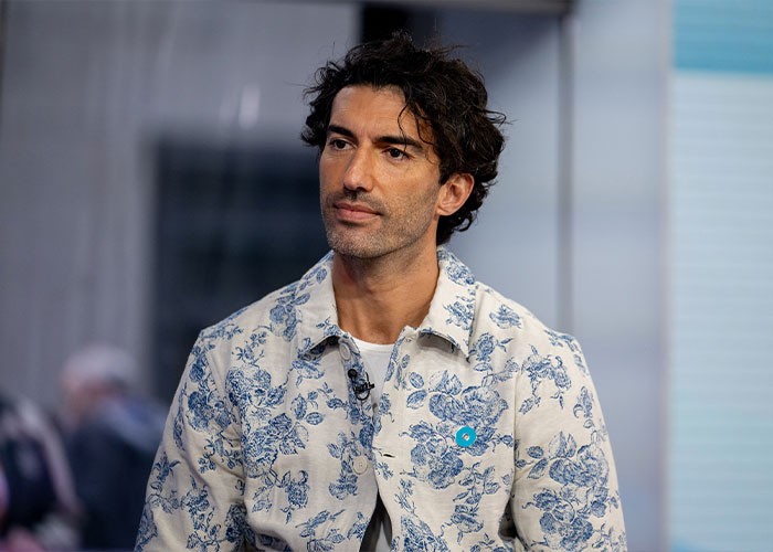 Justin Baldoni wearing a floral shirt, appearing thoughtful in an interview about his legal mistake and countersuit.