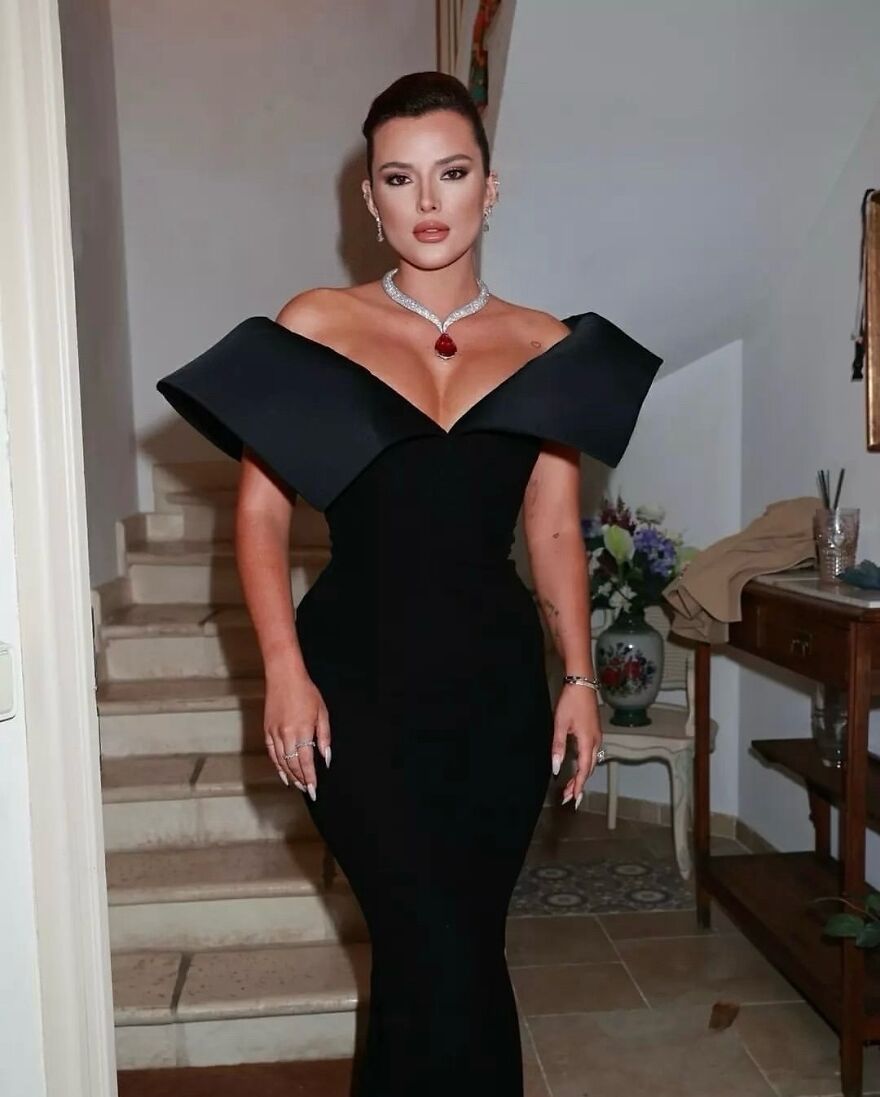 Bella Thorne in an elegant black dress and statement necklace, featured among celebrities on members-only fan pages.