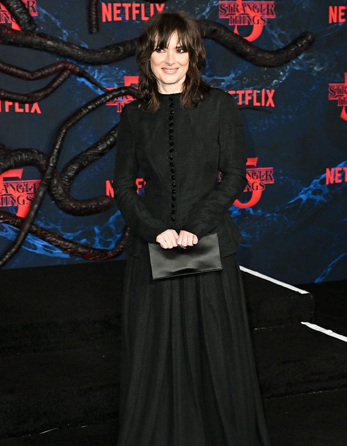 Woman in a black gothic-inspired outfit at the Stranger Things 5 premiere showcasing one of the strangest red carpet outfits.