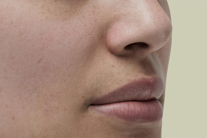 Close-up of a person's face showing skin texture and lips, illustrating an Oscar-worthy performance in subtle expression.