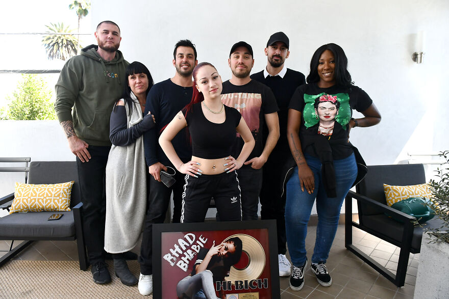 Bhad Bhabie posing with her team indoors, highlighting Bhad Bhabie net worth success in pop culture achievement.