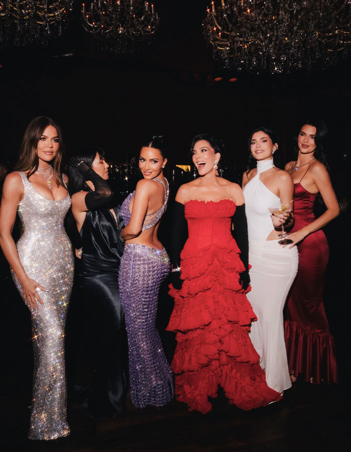 Kris Jenner&rsquo;s family in glamorous gowns posing at a formal event, sparking debate about her least favorite family member.