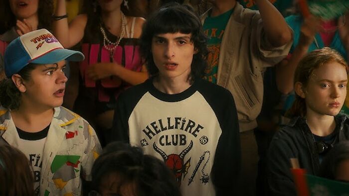 Main cast of Stranger Things in a tense scene, highlighting creators' cryptic warning for fans before final episodes release.