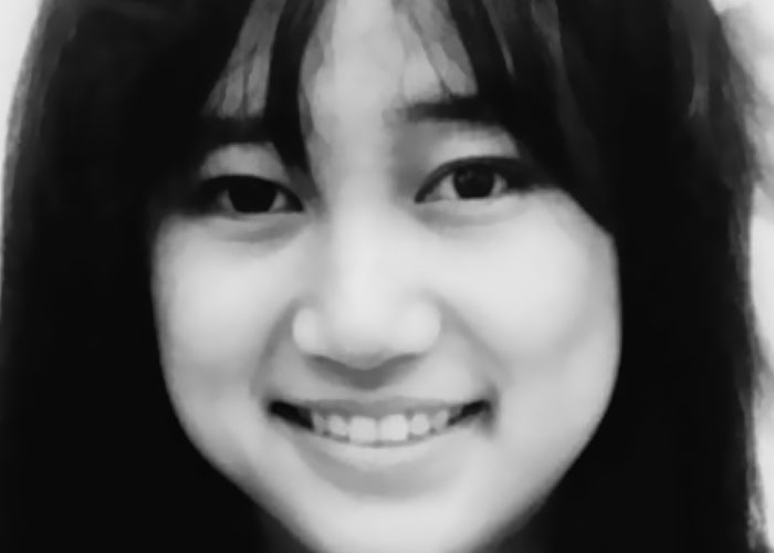 Close-up of a smiling woman with dark hair, related to people sharing the most terrifying things they’ve found online.