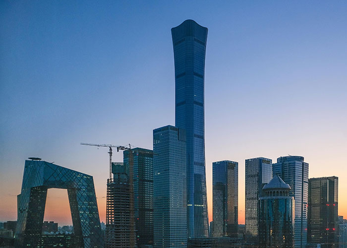 Skyline of a city with modern skyscrapers at dusk, representing one of the worst cities worldwide you should never visit.