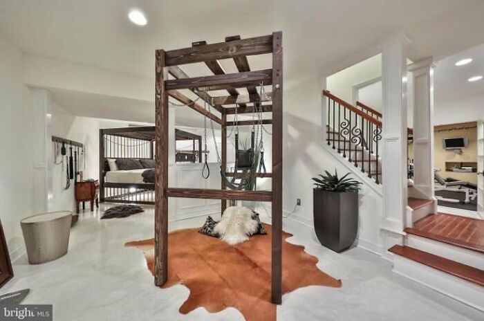Unique Zillow homes interior featuring a wooden swing set and modern decor in a spacious, bright living area.