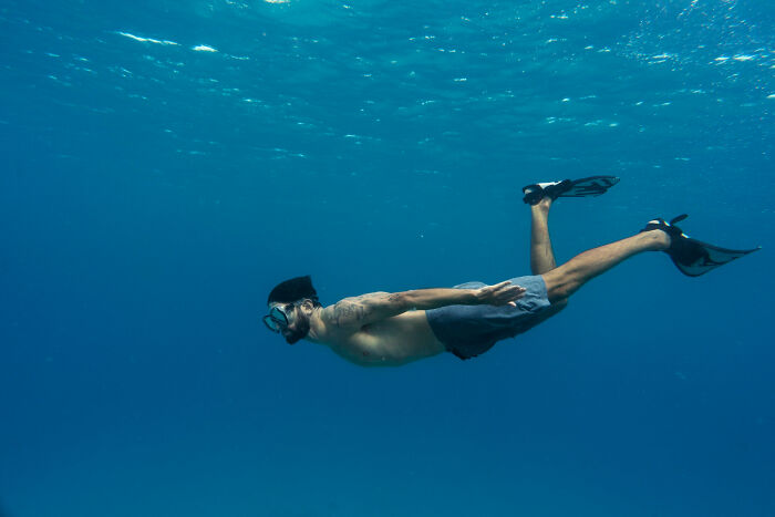 Man snorkeling underwater with fins and mask, illustrating a story about a little lie that backfired hard.