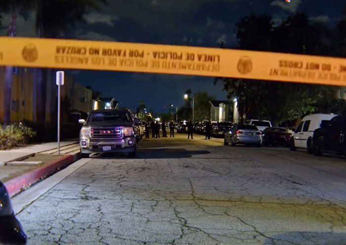 Crime scene at night in Los Angeles with police tape blocking street after singer DELAROSA assassinated, suspects still at large. Crime scene at night in Los Angeles with police tape blocking street after singer DELAROSA assassinated, suspects still at large.