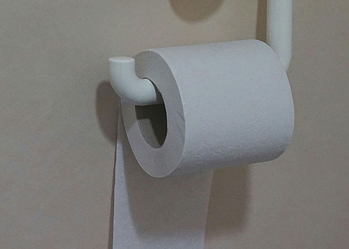 Close-up of a toilet paper roll on a holder illustrating simple genius cleaning hacks inspired by laziness.