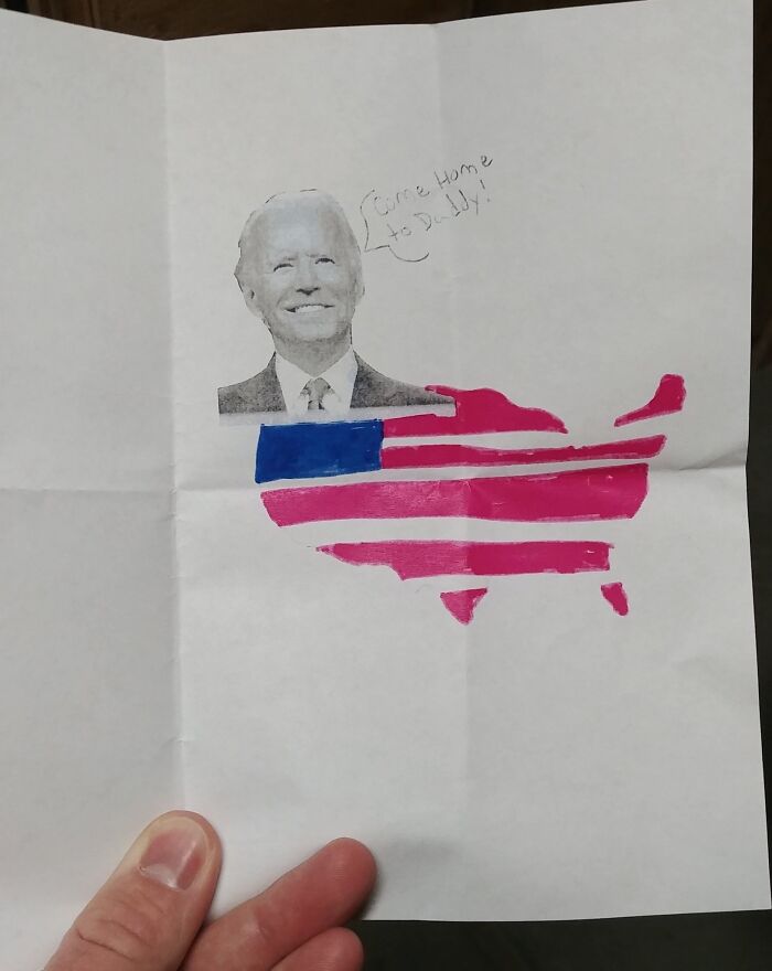 Hand holding a humorous letter with a cutout of a man&rsquo;s face and a stylized American flag shaped like the USA map.