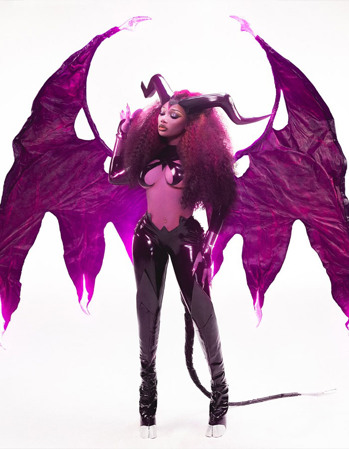 Woman in detailed Halloween costume with large purple wings and horns, showcasing creative celebrity Halloween costume ideas.