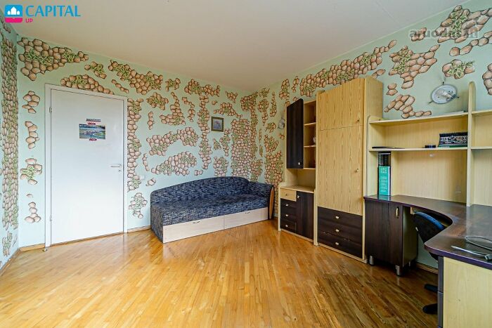 Room with unusual wall decorations and wooden furniture featured in wild real estate listings to help sell properties