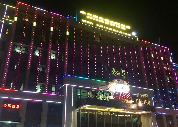 Jin Bei Casino building at night with colorful neon lights in one of the worst cities worldwide to avoid.
