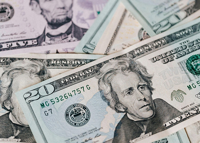 Close-up of US twenty dollar bills representing fascinating items people found hidden in the walls of their homes.