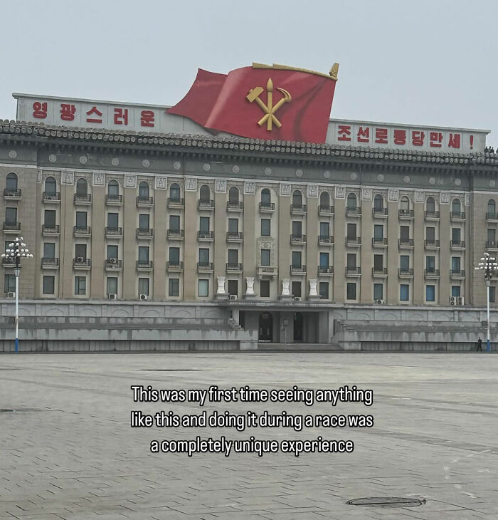 Building with a large red North Korean flag atop, captured by American travel influencer during marathon in North Korea.