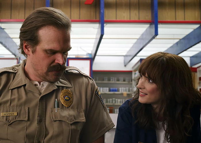 David Harbour and Stranger Things co-star in a scene, showcasing their on-screen chemistry and connection.