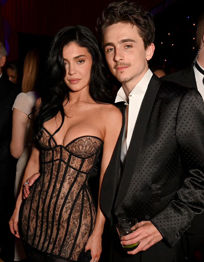 Timothée Chalamet poses at an event, sparking backlash over his comments about having kids in a black patterned suit. Timothée Chalamet poses at an event, sparking backlash over his comments about having kids in a black patterned suit.