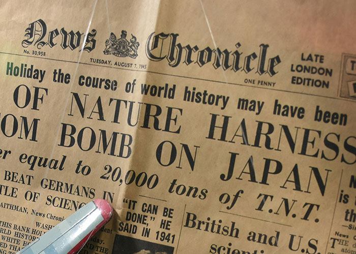 Old newspaper found in the walls of a home, showcasing a historical headline about world events from 1945.