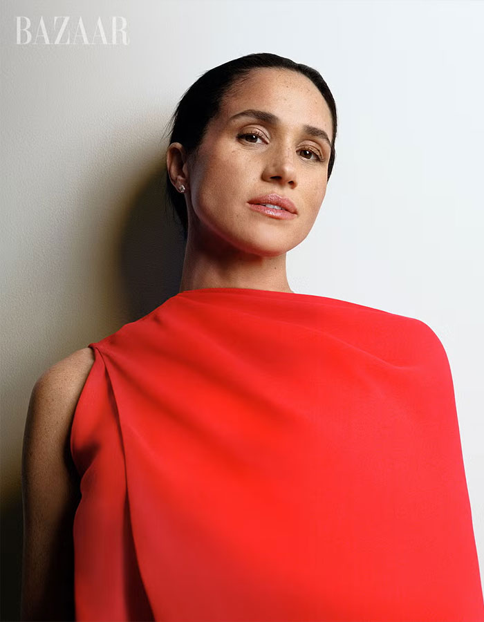 Meghan Markle posing in a striking red outfit for her Harper&rsquo;s Bazaar moment capturing attention online.