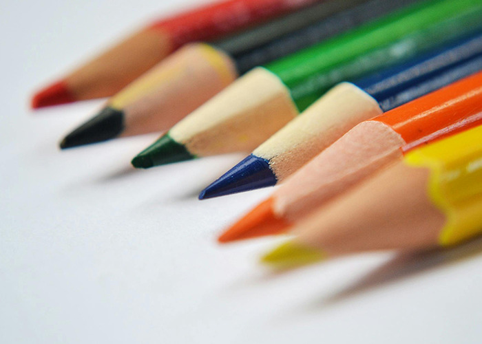 Close-up of colorful sharpened pencils arranged in a row, illustrating unusual or horrible gifts received by people.