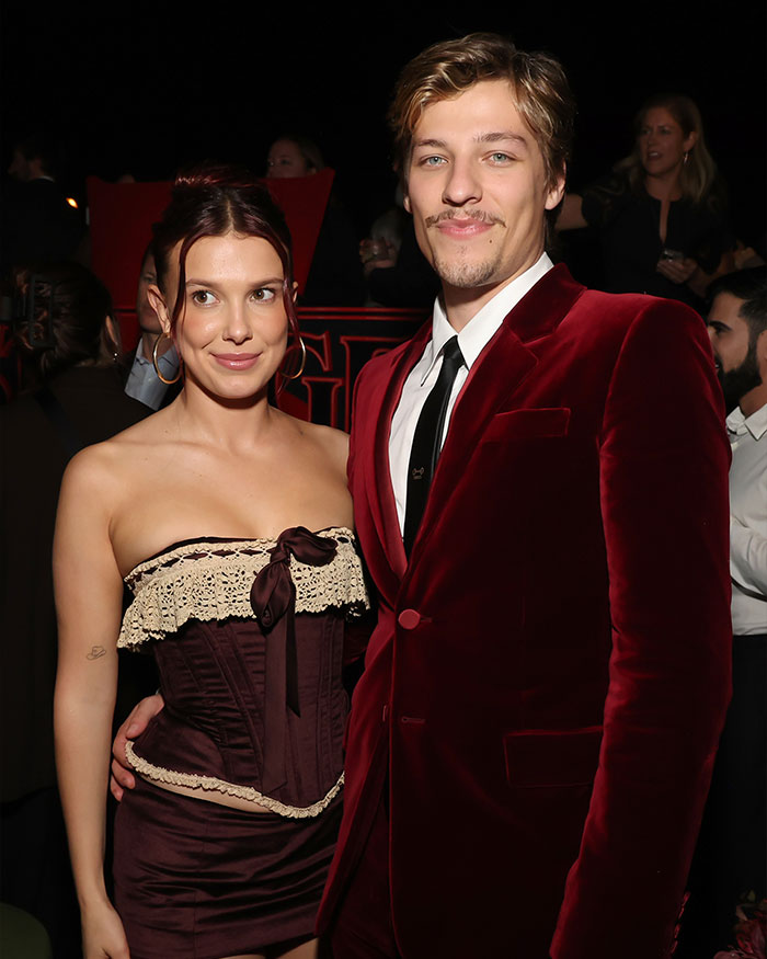 Millie Bobby Brown at event with companion, fans reacting to news of her legal name change in Hollywood setting