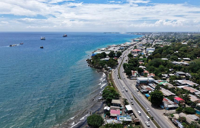 Aerial view of coastal road and buildings in the poorest country in the world facing dire hardship.