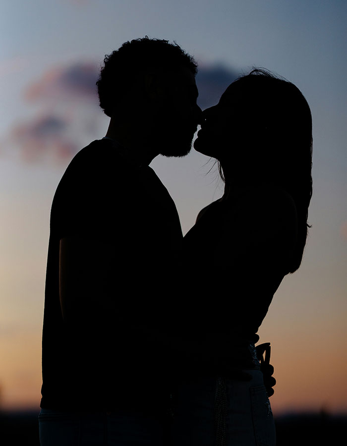 Silhouette of a trainee police officer and her boyfriend sharing a close moment at sunset, hinting at secretive relationship. Silhouette of a trainee police officer and her boyfriend sharing a close moment at sunset, hinting at secretive relationship.