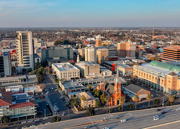 Aerial view of a city with various buildings and streets, illustrating some of the worst cities worldwide to avoid.