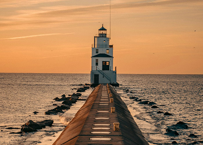 Lighthouse at sunset overlooking ocean, illustrating common knowledge that seems to blow people's minds.