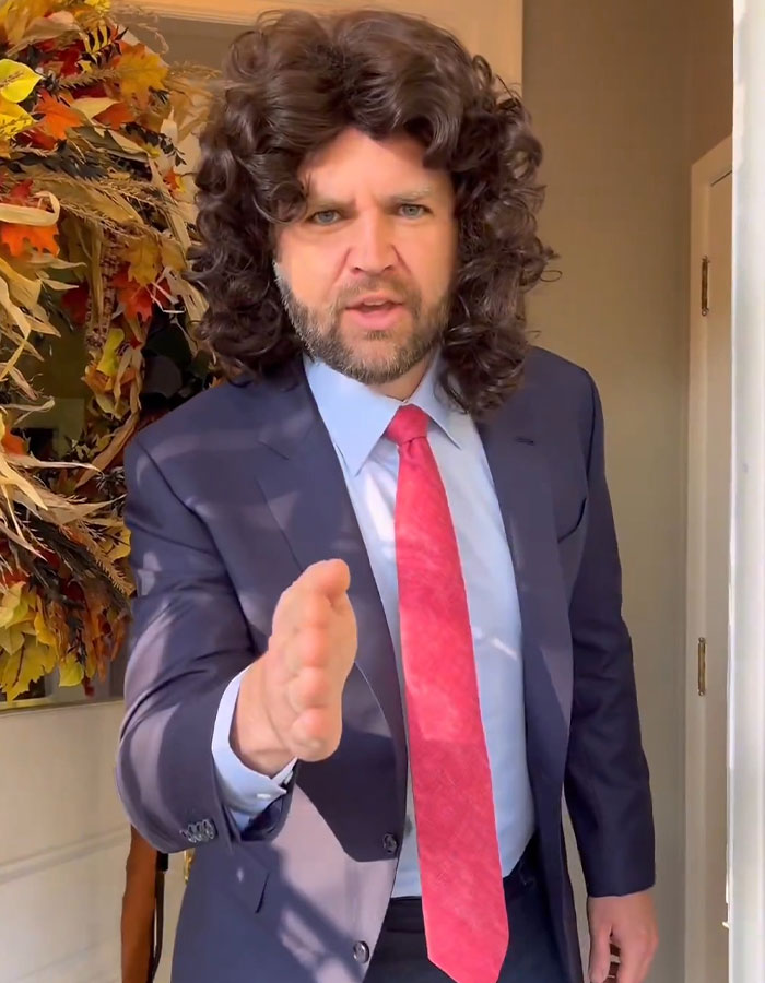 Man dressed in Halloween costume with curly wig and suit, showcasing one of the best celebrity Halloween costumes.