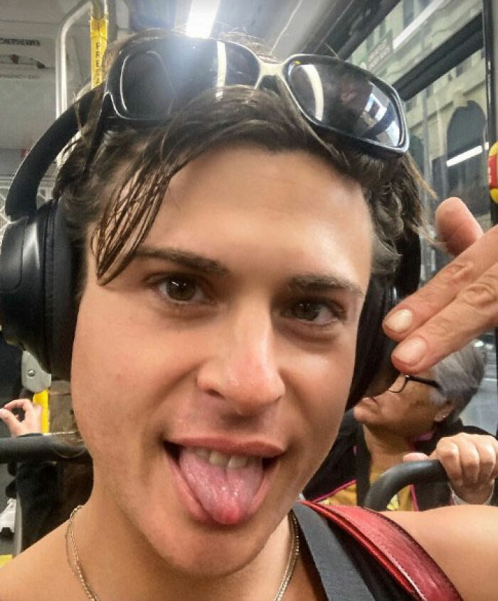 Close-up of Joey Swoll wearing headphones and sunglasses indoors, expressing a playful mood amid Gold's Gym trans locker controversy. Close-up of Joey Swoll wearing headphones and sunglasses indoors, expressing a playful mood amid Gold's Gym trans locker controversy.