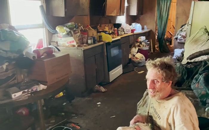 Man sitting in cluttered, dirty kitchen inside a rundown home linked to America&rsquo;s most inbred family viral fame aftermath.