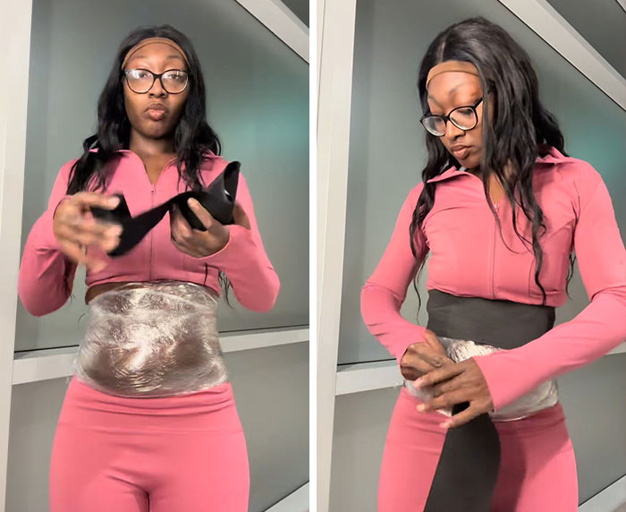 Woman demonstrating trick to hide loose skin on her belly after massive weight loss, wearing pink workout clothes indoors.