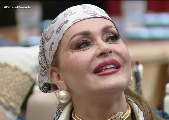 Actress with makeup and headscarf smiling, featured in plastic surgery clinic unrecognizable before-after pictures debate.