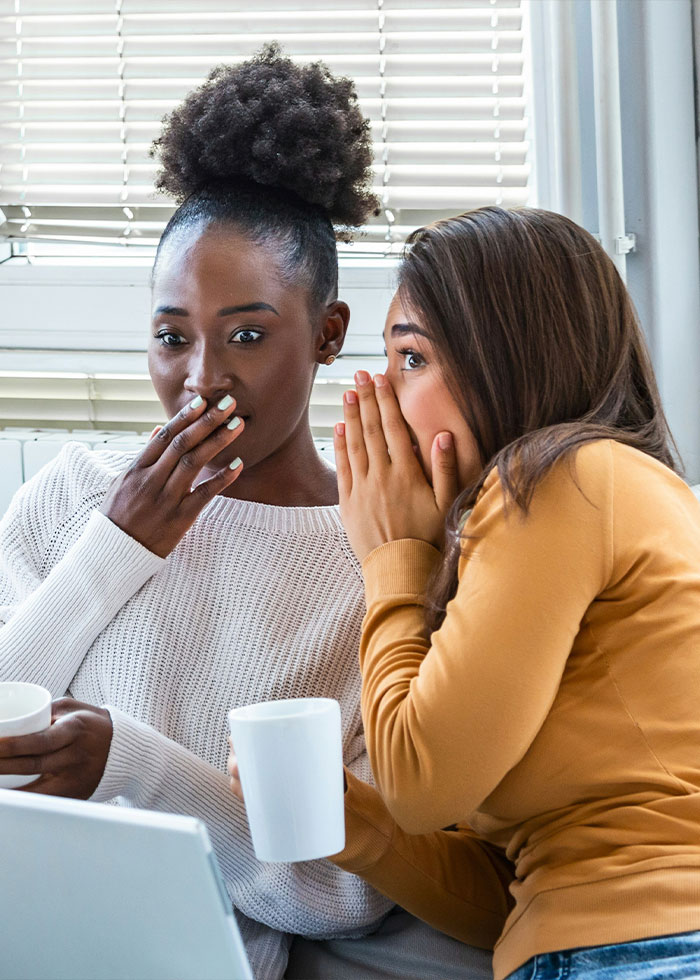 Two women sharing a secret while drinking coffee, illustrating red flags that could mean someone is a narcissist. Two women sharing a secret while drinking coffee, illustrating red flags that could mean someone is a narcissist.