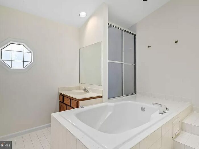 Modern bathroom with large bathtub and shower enclosure in unique Zillow homes you have to see to believe