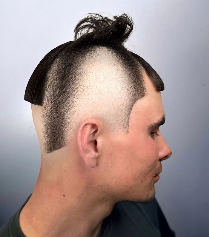 Young man with a bold barber haircut featuring shaved sides and a unique textured fringe hairstyle.