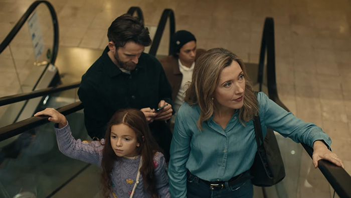 Family on an escalator, illustrating why parents shouldn't post about their children online, highlighting online privacy concerns. Family on an escalator, illustrating why parents shouldn't post about their children online, highlighting online privacy concerns.